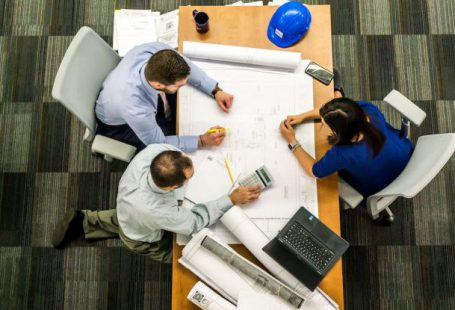 Risk Management - Three People Sitting Beside Table