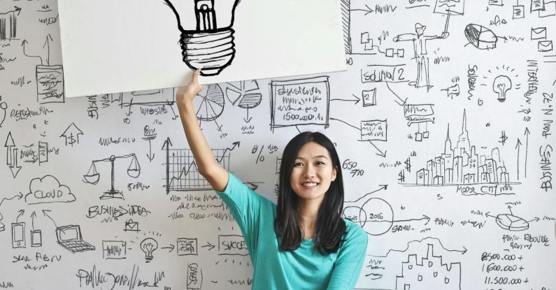 Business Idea - Woman Draw a Light bulb in White Board