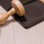 Authority - Wooden stamp on ink pad placed on desk