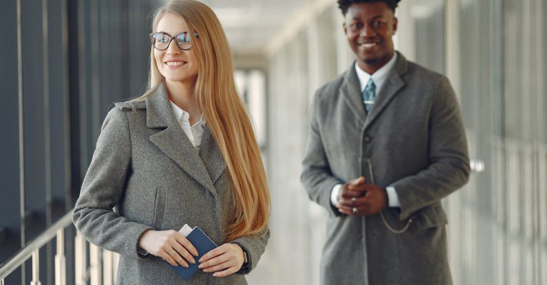 Diverse Corporate Board - Cheerful business people with passport in airport hall