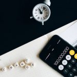 Enterprise Risk Management - Black Remote Control Beside Silver Round Analog Wall Clock