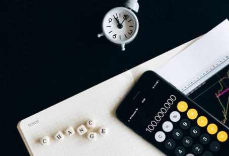 Enterprise Risk Management - Black Remote Control Beside Silver Round Analog Wall Clock