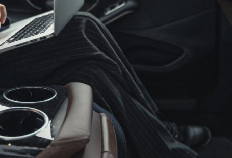 Transformational Leader - Person Seated At The Back Seat Using Macbook