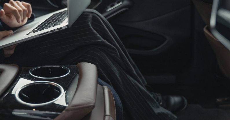 Transformational Leader - Person Seated At The Back Seat Using Macbook