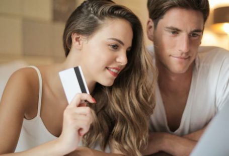 Customer Relationship Management - Cheerful couple making online purchases at home