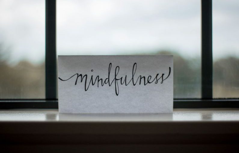 Coaching Leadership - mindfulness printed paper near window